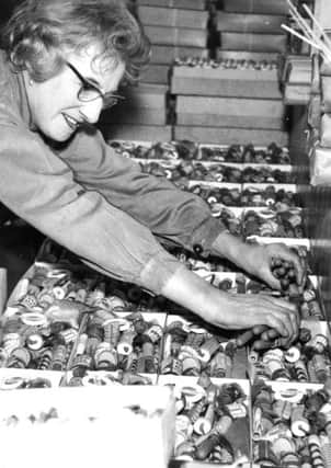 Huddersfield, 3rd April 1964

Standard Fireworks factory.

A popular item nowadays is the packed selection box costing anything between 2s. 6d. and Â£5.

Here, Mrs. Elizabeth Swift deftly fills 36 boxes at a time with a selection of fireworks.

They are then moved to the packing department and from there go into cold storage several hundred yards away from the manufacturing section.