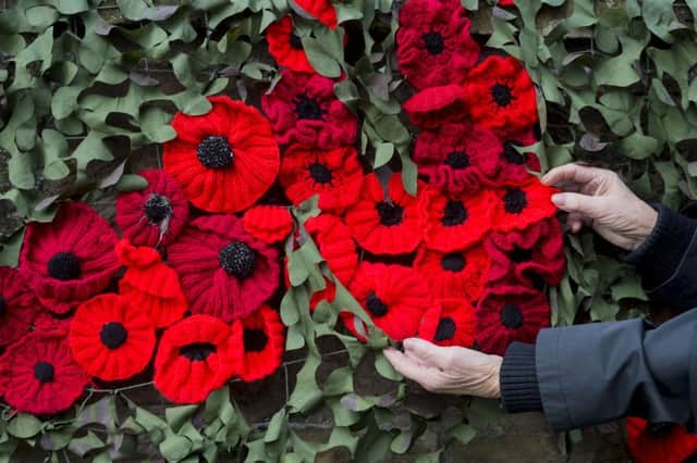 Date: 7th November 2016. Picture James Hardisty.
Thirsk Yarnbombers have been stringing thousands of knitted poppies around Thirsk, for the run up to Remembrance Day including a large draped display on the side of St Mary's Church, Thirsk. Pictured A sample of the thousands on poppies on display.