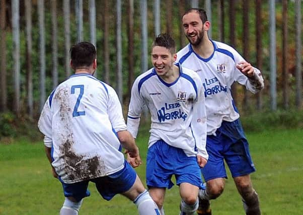 Matthew Waller, centre, celebrates after his last goal made the score 3-1 to Hope Inn at Seacroft.