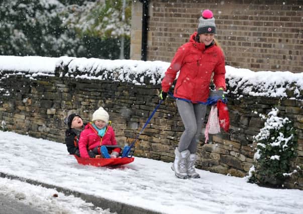 Emma Lowe-Marshall pulls Harry 5, and Edie , 3, to school in a sledge. PIC: Tony Johnson