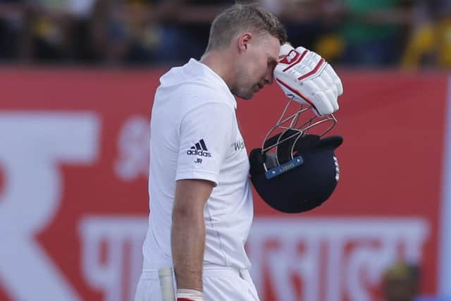England's batsman Joe Root walks back after losing his wicket during the first day of the first test cricket match between India and England in Rajkot, India. (AP Photo/Rafiq Maqbool)