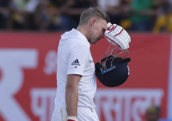 England's batsman Joe Root walks back after losing his wicket during the first day of the first test cricket match between India and England in Rajkot, India. (AP Photo/Rafiq Maqbool)
