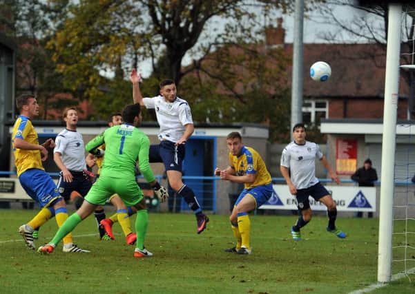 SECOND STRIKE: Guiseley's Jake Cassidy powers in the second goal. Picture: Tony Johnson.