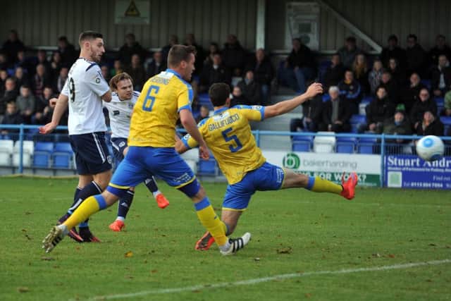 ON TARGET: Guiseley's  Jordan Preston, second left, fires in tthe home side's first goal against Torquay. Picture: Tony Johnson.