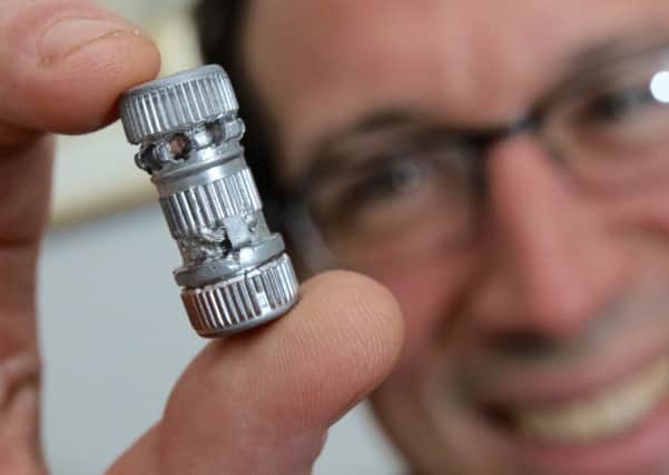 A British doctor is hoping to pick up a world record for the smallest bagless vacuum cleaner - just 2.8cm long. See SWNS story SWHOOVER; Brainy Toby Bateson, 38, built the tiny machine by hand at home using a bottle to store samples of blood from animals he bought from an online veterinary supplier. The dad from Truro, Cornwall, who started dabbling in engineering the tiny bagless cleaners as a child, is now set to have it registered with the Guinness World Records later this month. He put in a total of nine hours of work before he had the vacuum cleaner switched on and working - and although he accepts it may not be commercially viable it was a handy tool to suck up dust.