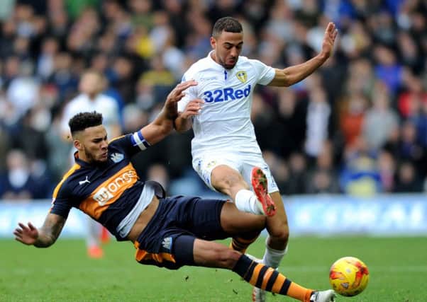 Kemar Roofe is tackled by Newcastle United's Jamaal Lascelles.