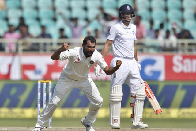 GOTCHA: India's Mohammed Shami, left, celebrates the dismissal of England's Joe Root, right, on the last day in Visakhapatnam. Picture: AP/Aijaz Rahi.