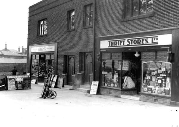 1937: The window being dressed at the Oakwood Lane Thrift Stores.