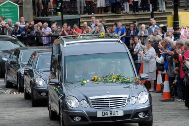 Crowds pay their respects during the funeral of Mrs Cox.