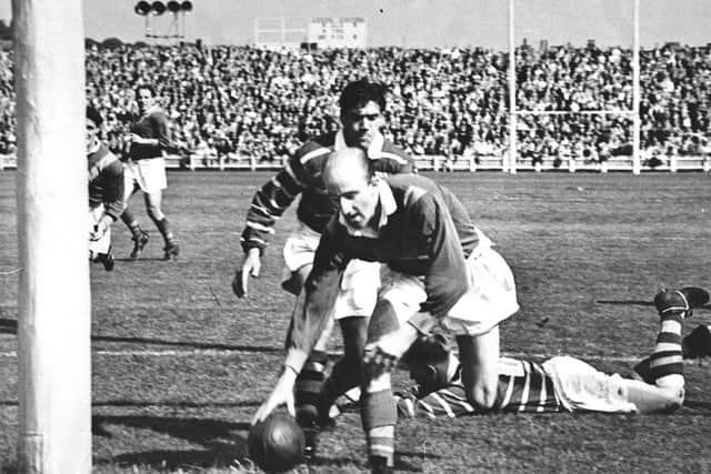 1956: Lewis Jones of Leeds RL places the ball under the posts  at Headingley.