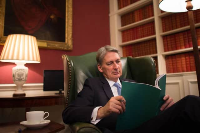 Chancellor Philip Hammond looks over the Autumn Statement he will deliver today