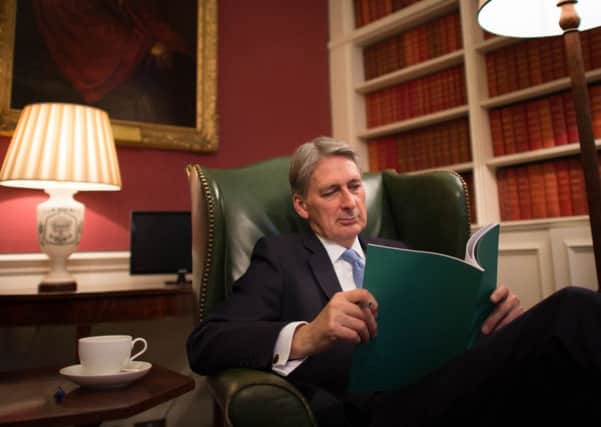 Chancellor Philip Hammond looks over the Autumn Statement he will deliver today