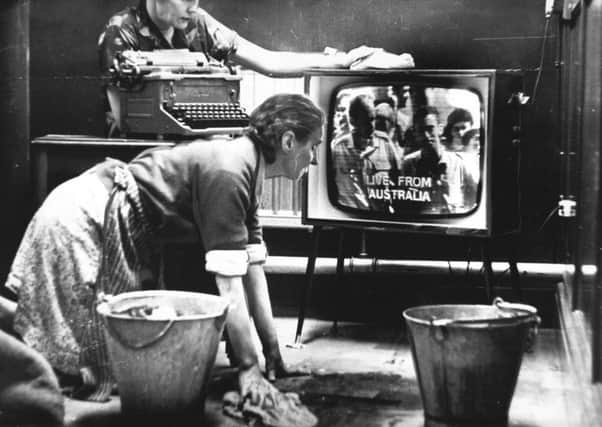 24th November 1966

The time is 6.30 am today in a Leeds office and two cleaners, Mrs. Annie Burke (kneeling) and Mrs. Lily Backhouse, watch a great moment in TV, live transmission for the first time, of pictures direct from Australia via the satellite