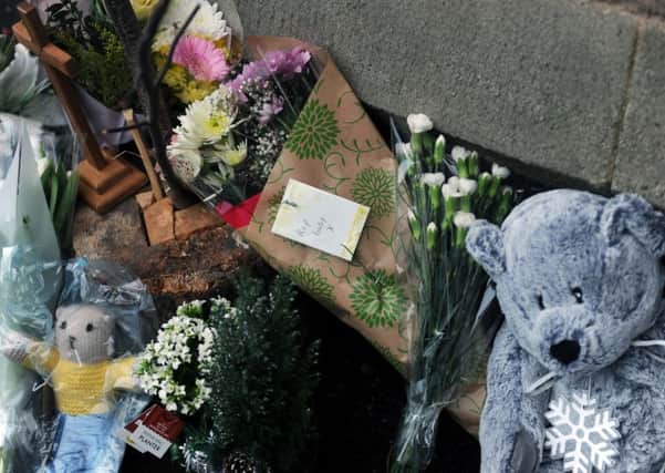 Tributes left outside St Peter's Church in Bramley following news of the baby boy's death.
