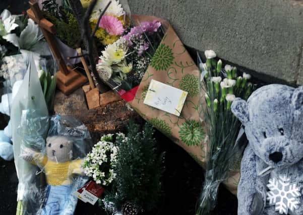 Floral tributes and teddies have been left outside St Peter's Church in Bramley.