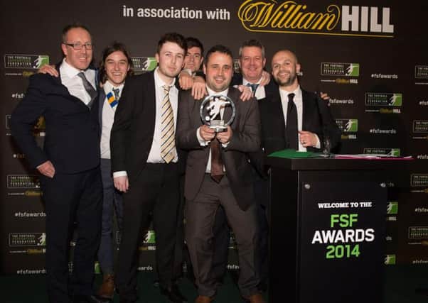 The Square Ball team celebrate their win at the 2014 Football Supporters Federation Awards.