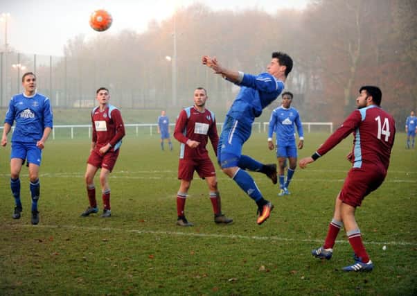Brad Chambers powers home a header to score for Leeds Medics and Dentists against Wigton Moor in the Yorkshire Amateur League.