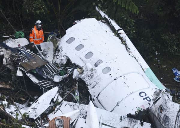 Rescue workers search at the wreckage site of a chartered airplane that crashed outside Medellin, Colombia.