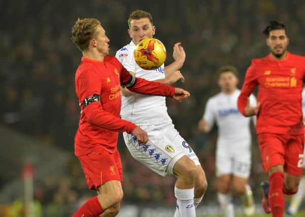 Liverpool's Lucas and United's Chris Wood challenge for the ball.