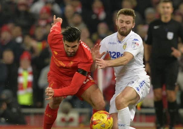 Stuart Dallas battles for the ball with Emre Can.