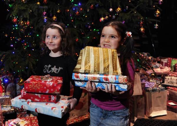 Yorkshire Evening Post carol service at Leeds Minster. Sx-year-olds Madeleine-Ava Smith and Eimear Langham, put their presents round the tree.
1st December 2016.
Picture : Jonathan Gawthorpe