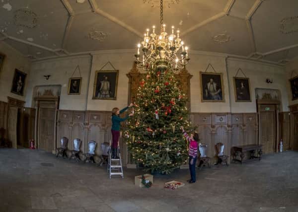 DECORATING: The tree takes shape at Temple Newsam. PIC: James Hardisty