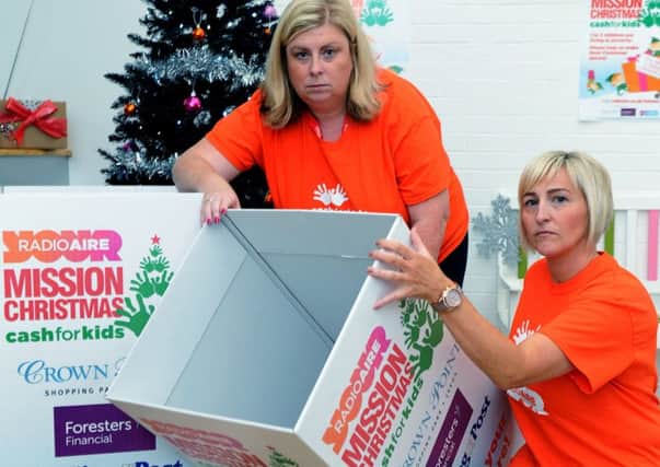 Mission Christmas...........  Radio Aire's Cash for Kids volunteers Lisa Sullivan and Lisa Williams with empty boxes, as they appeal for more gifts.