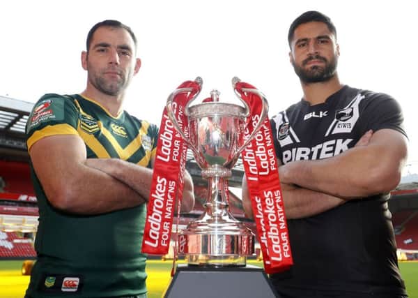 New territory: Australia captain Cameron Smith, left, and New Zealand counterpart Jesse Bromwich led their sides in the Four Nations final which was played at Anfield, the home of Liverpool FC, and which attracted a crowd of around 40,000 to  watch the green and golds triumph. (Picture: Martin Rickett/PA)
