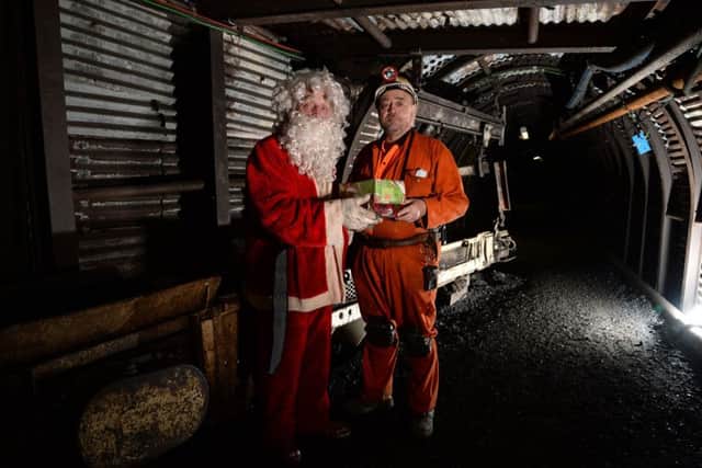 Former miners John Carrington inside Britain's deepest Christmas Grotto giving visitors a chance to visit Santa 140m underground in his winter grotto at the National Coal Mining Museum
