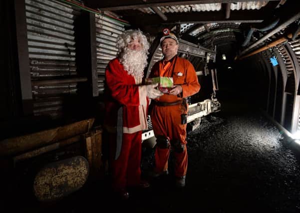 Former miners John Carrington inside Britain's deepest Christmas Grotto giving visitors a chance to visit Santa 140m underground in his winter grotto at the National Coal Mining Museum