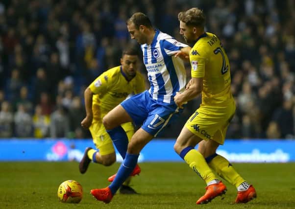 Glenn Murray (left) and Leeds United's Charlie Taylor battle for the ball. PIC: PA