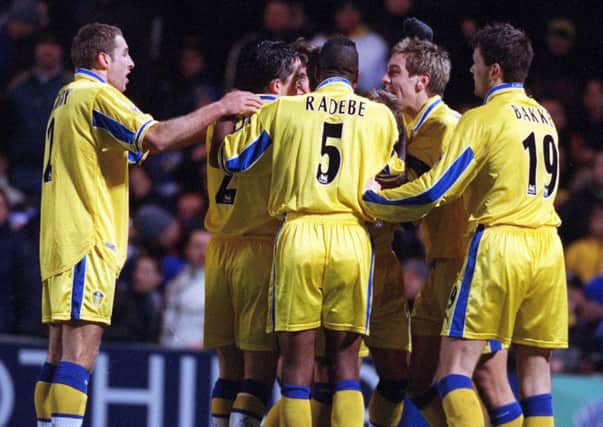 Leeds players mob Stephen McPhail after his second goal at Chelsea gave Leeds victory.