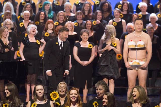 David Walliams gives Gary Barlow a shock when he turns up on stage at the Royal Variety Performance wearing nothing but his pants and a string of pearls. PIC: PA