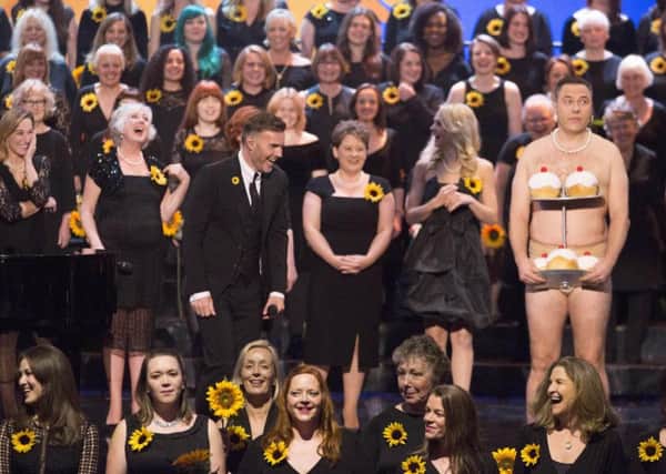 David Walliams gives Gary Barlow a shock when he turns up on stage at the Royal Variety Performance wearing nothing but his pants and a string of pearls. PIC: PA