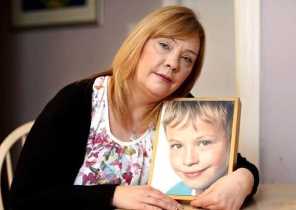 LOVING MEMORY: Heartbroken Pam Whitlam holds a photo of her son Harry.