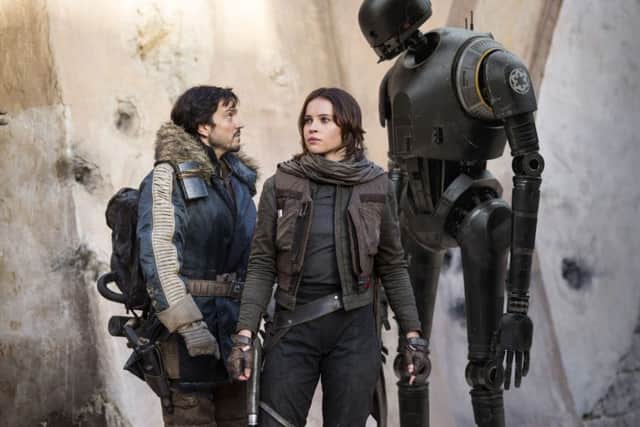 Undated Film Still Handout from Rogue One: A Star Wars Story. Pictured: Cassian Andor (Diego Luna), Jyn Erso (Felicity Jones) and K-2SO (Alan Tudyk). See PA Feature FILM Reviews. Picture credit should read: PA Photo/Lucasfilm. WARNING: This picture must only be used to accompany PA Feature FILM Reviews.
