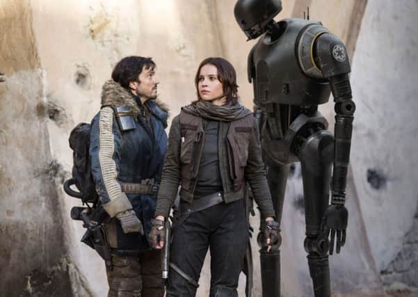 Undated Film Still Handout from Rogue One: A Star Wars Story. Pictured: Cassian Andor (Diego Luna), Jyn Erso (Felicity Jones) and K-2SO (Alan Tudyk). See PA Feature FILM Reviews. Picture credit should read: PA Photo/Lucasfilm. WARNING: This picture must only be used to accompany PA Feature FILM Reviews.