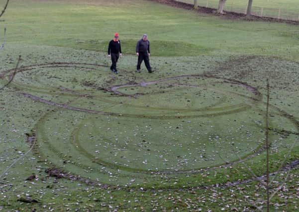 UPSET: Club director Andy Inglefield and green keeper Clive Walton survey the damage.