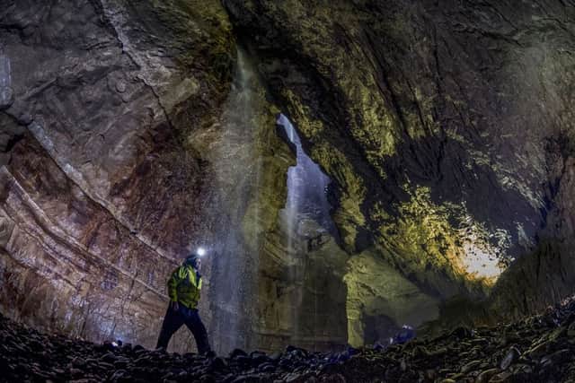 Date:27th May 2016. Picture James Hardisty.
Gaping Gill, situated on the SW slopes of Ingleborough at an altitude of 1300ft (400m) above sea level in the heart of the Yorkshire Dales. A natural cave in North Yorkshire and probably the most well known pothole in the United Kingdom. Twice a year between May and August two local caving clubs Bradford Pothole and Craven Pothole arrange the Gaping Gill Winch. This is where cavers can explorer well known tunnels and visitors to the site are lowered in a chair decending 330ft(100m) through Britainâ¬"s highest unbroken waterfall as it lands on the floor of Gaping Gill, the largest cavern in Britain, known as the Main Chamber and large enough to fit most of York Minster, two Boeing 747 Jumbo Jets, the volume of 18 Olympic swimming pools or the plan area of ten doubles tennis courts. Pictured Bradford Pothole Club Secretary Ian Cross, aged 58, in the main chamber of Gaping Gill.