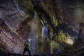Date:27th May 2016. Picture James Hardisty.
Gaping Gill, situated on the SW slopes of Ingleborough at an altitude of 1300ft (400m) above sea level in the heart of the Yorkshire Dales. A natural cave in North Yorkshire and probably the most well known pothole in the United Kingdom. Twice a year between May and August two local caving clubs Bradford Pothole and Craven Pothole arrange the Gaping Gill Winch. This is where cavers can explorer well known tunnels and visitors to the site are lowered in a chair decending 330ft(100m) through BritainÃ¢Â¬"s highest unbroken waterfall as it lands on the floor of Gaping Gill, the largest cavern in Britain, known as the Main Chamber and large enough to fit most of York Minster, two Boeing 747 Jumbo Jets, the volume of 18 Olympic swimming pools or the plan area of ten doubles tennis courts.  Pictured Bradford Pothole Club Secretary Ian Cross, aged 58, in the main chamber of Gaping Gill.