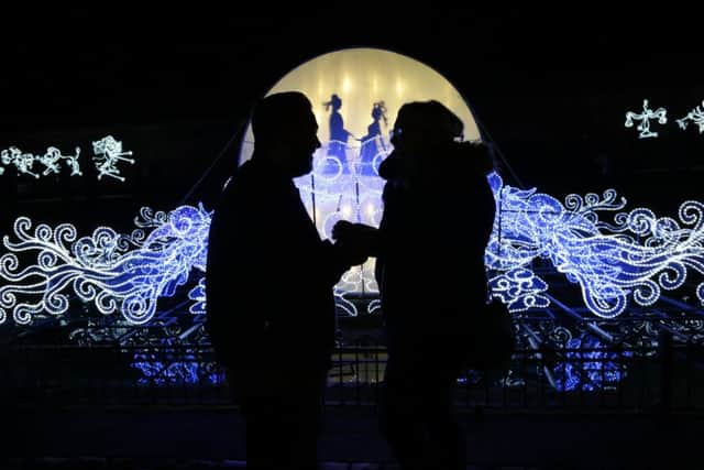 Stefan Hibbitt, from Alwoodley, went down on one knee to propose to his girlfriend of eight years Amy Brown, 22, in front of the romantic Love Bridge at the Magical Lantern Festival Yorkshire in Roundhay Park, Leeds. Image: Pat Bannon