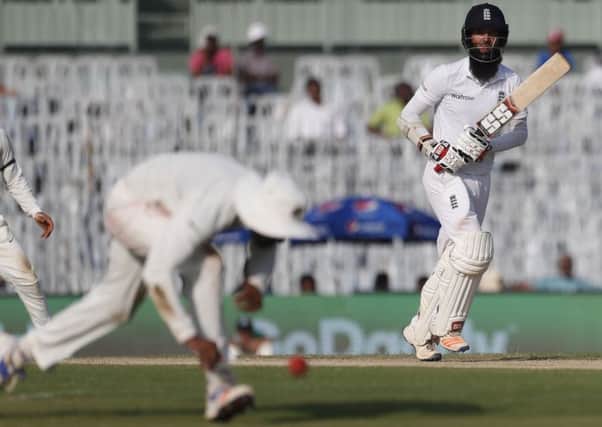 England's Moeen Ali, right, runs between the wickets in Chennai. Picture: AP/Tsering Topgyal)