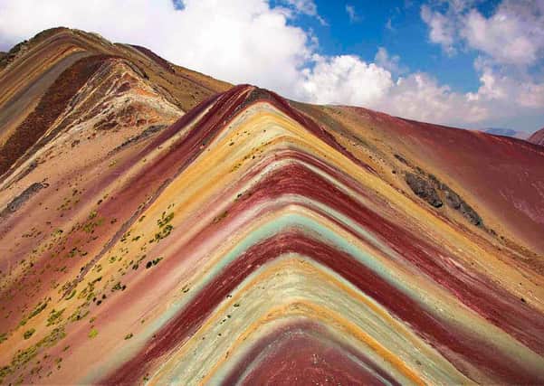 A psychedelic rainbow mountain has been discovered in Peru & captured by video drone for the first time.Travellers from the UK climbed to the peak of the mountain which is at 5000 metres above sea level. Photographer Lee Thompson of Flash Pack tours captured the incredible drone footage after trekking 9.3 miles to the peak of the Vinicunca mountain in the South American Andes. Using horses to carry the kit they camped at the foot of the mountain to wait for snow to stop falling before making it to the peak the following day. With the help of expert guides all the Flash Pack group successfully made it to the top and now have amazing drone footage to remember it and give them ultimate bragging rights on social media! Lee said - This really is South Americas best kept secret!