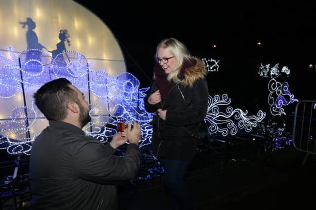 Stefan Hibbitt, from Alwoodley, went down on one knee to propose to his girlfriend of eight years Amy Brown, 22, in front of the romantic Love Bridge at the Magical Lantern Festival Yorkshire in Roundhay Park, Leeds. Image: Pat Bannon