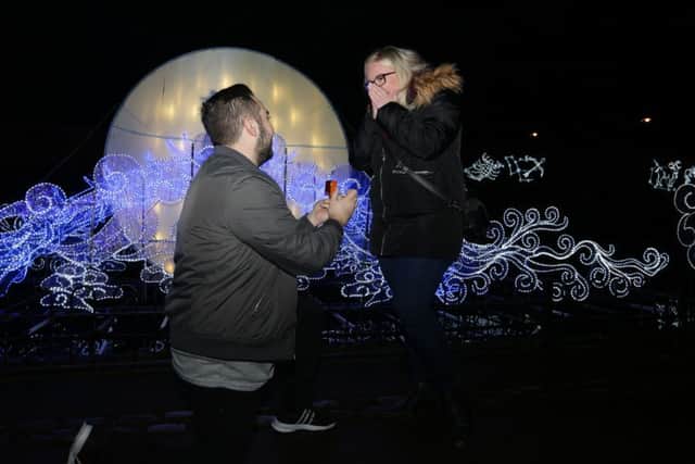 Stefan Hibbitt, from Alwoodley, went down on one knee to propose to his girlfriend of eight years Amy Brown, 22, in front of the romantic Love Bridge at the Magical Lantern Festival Yorkshire in Roundhay Park, Leeds. Image: Pat Bannon