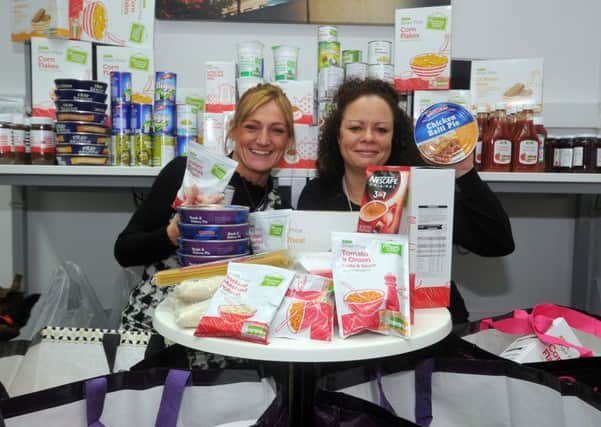 STOCKING UP: Tenancy officer Donna Smith and youth work Nadine Roche at Affinity Sutton in Leeds.