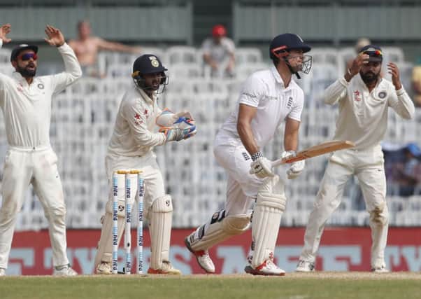 England's captain Alastair Cook, second right, watches a ball as India's captain Virat Kohli, first left, wicket keeper Parthiv Patel , second left, and Murali Vijay reacts during their fifth day of the fifth cricket test match in Chennai, India, Tuesday, Dec. 20, 2016. (AP Photo/Tsering Topgyal)