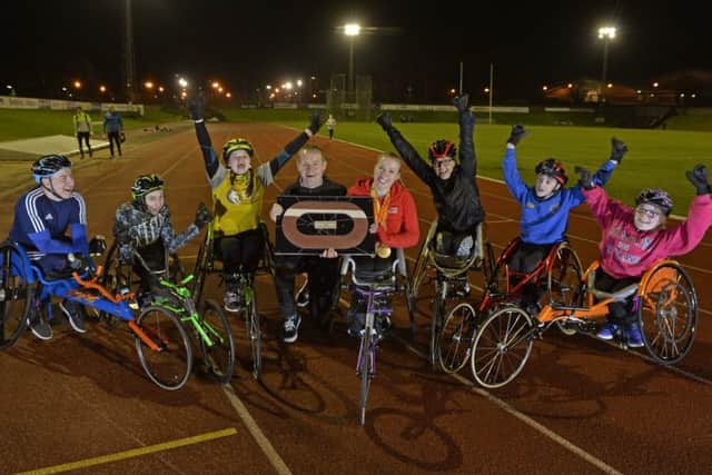 Hannah Cockroft presents Leeds City Athletics Club with commemorative piece of the London 2012 track.