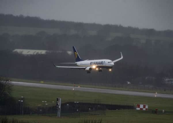 A Ryanair plane arriving at Leeds Bradford Airport from Poland makes its way onto the runway in high winds as Storm Barbara hits the UK.