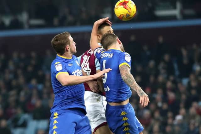 Leeds United's Liam Cooper (right) handles the ball in the area to concede a penalty.